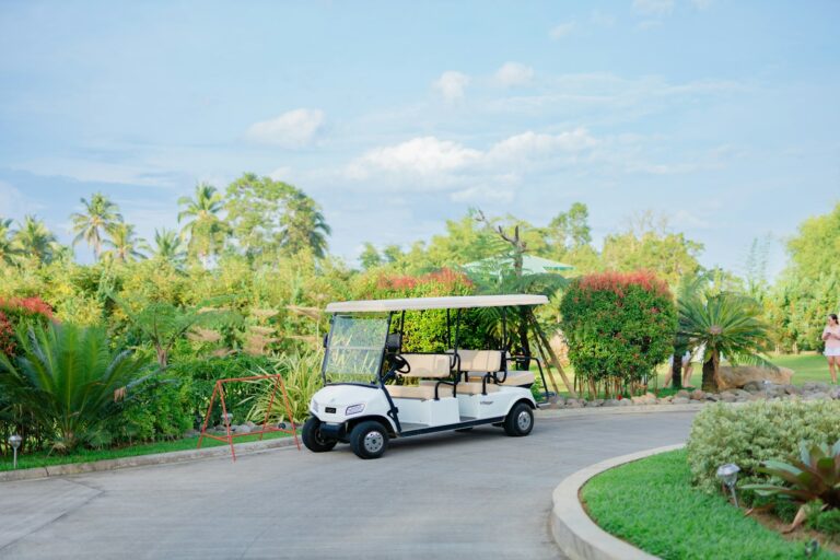 White golf cart parked on a paved road